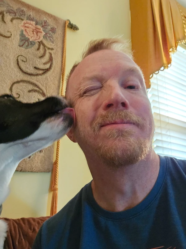 dog licking David